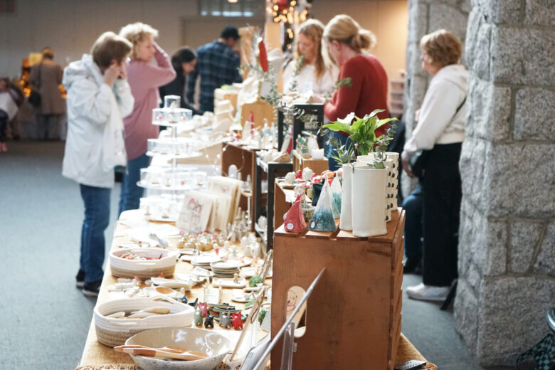 Vendors and visitors inside Shadbolt Centre, browsing artisan wares during the holidays